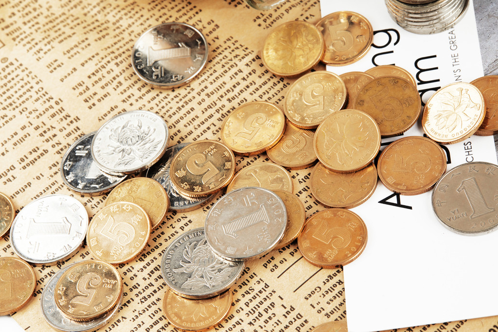 硬币堆放在桌上背景图片