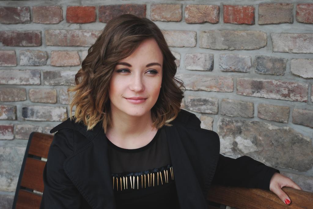 彩色人群清新美丽棕色短发黑衣女子坐在长椅上女孩拍照背景图片