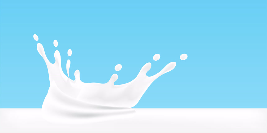蓝色背景下的牛奶飞溅形状漂亮健康生活方式