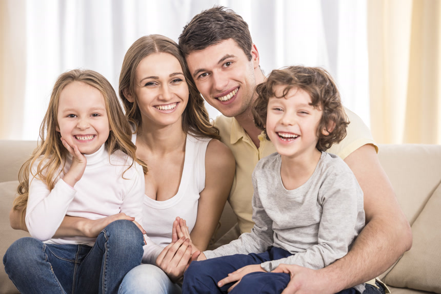 坐在沙发上的一家四口快乐的家庭家庭人像