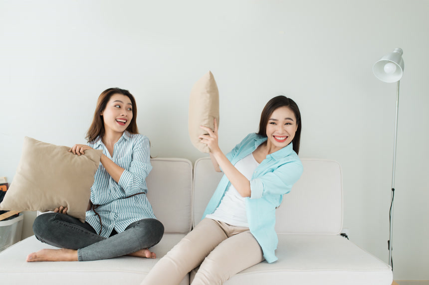 正在参与枕头大战的两位女性朋友休闲娱乐