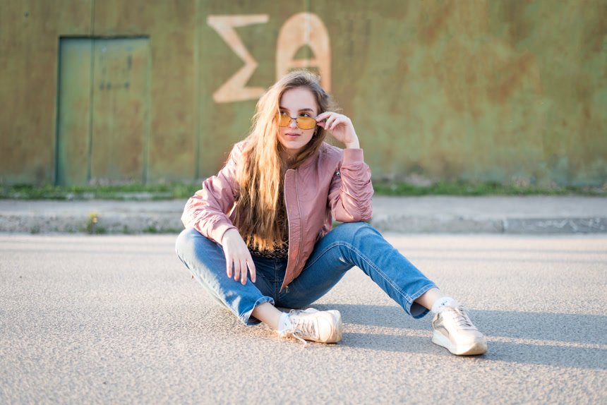 街上的年轻漂亮女人坐在地上生活方式 
