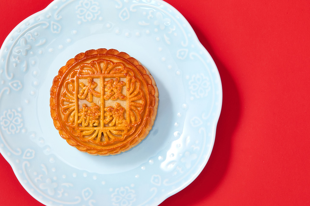 中秋月饼中秋元素中秋佳节迎中秋浓情中秋红底实拍瓷盘盘子月饼一块月饼中国风冰糖玫瑰中秋节配图