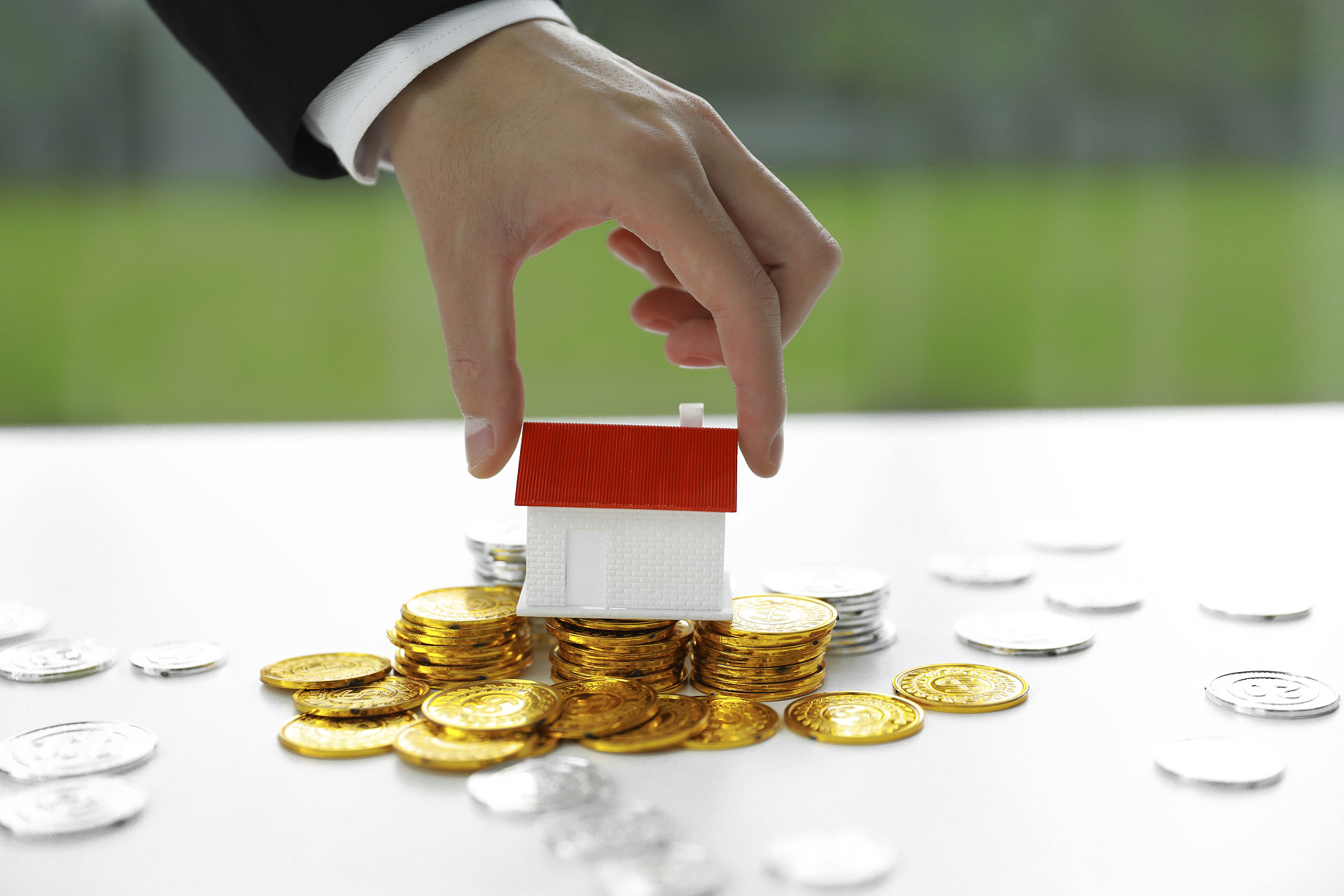 商务人像金币银币散落金币房子模型投资金融理财投资