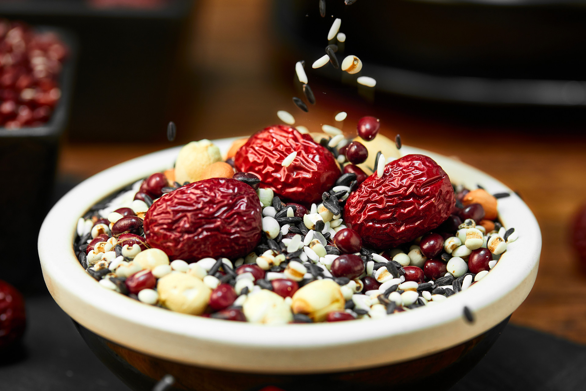 模糊背景瓷碗下落粮食腊八粥腊八节粮食八宝粥红枣