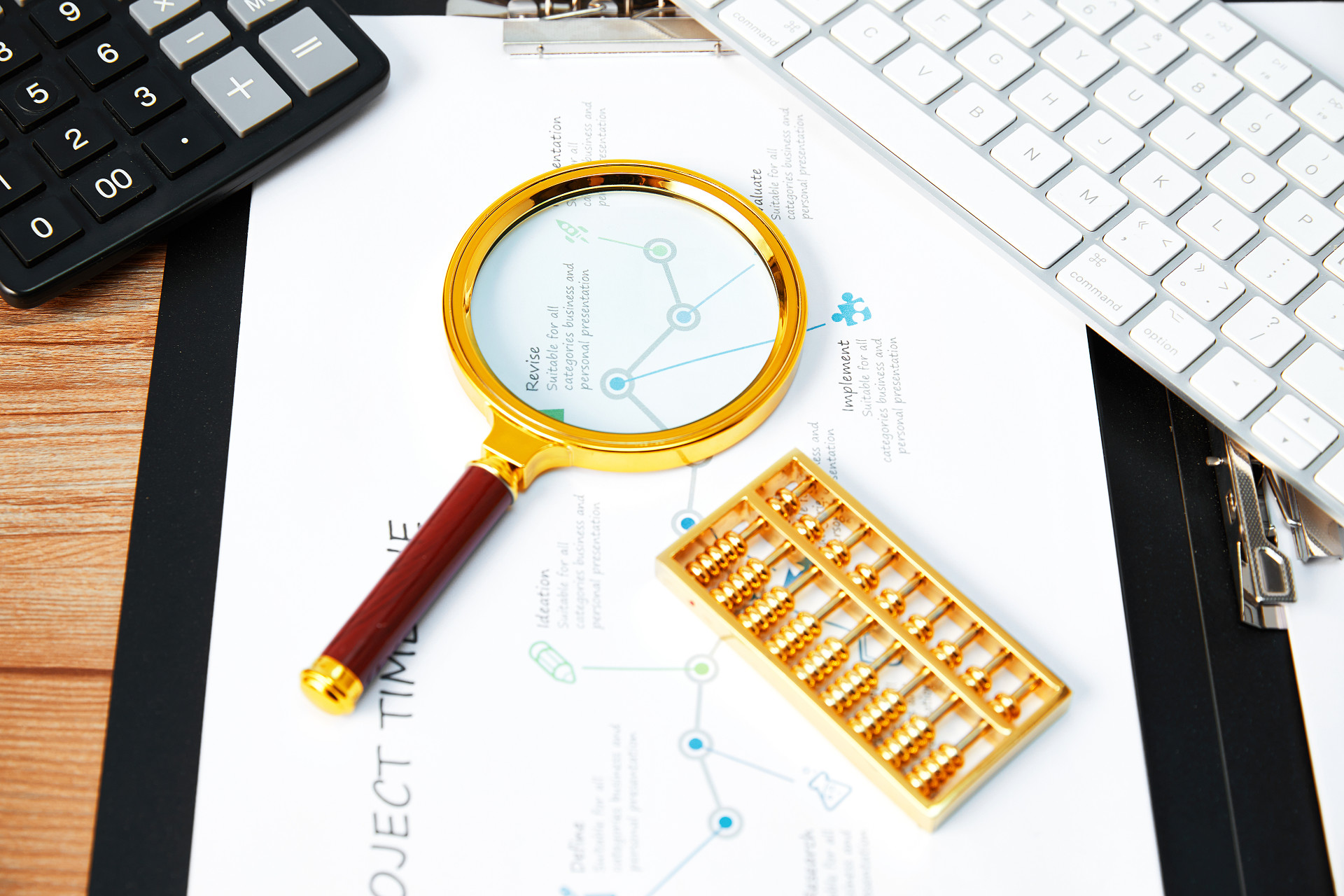 放大镜算盘金色算盘计算器白色键盘折线图统计图图纸