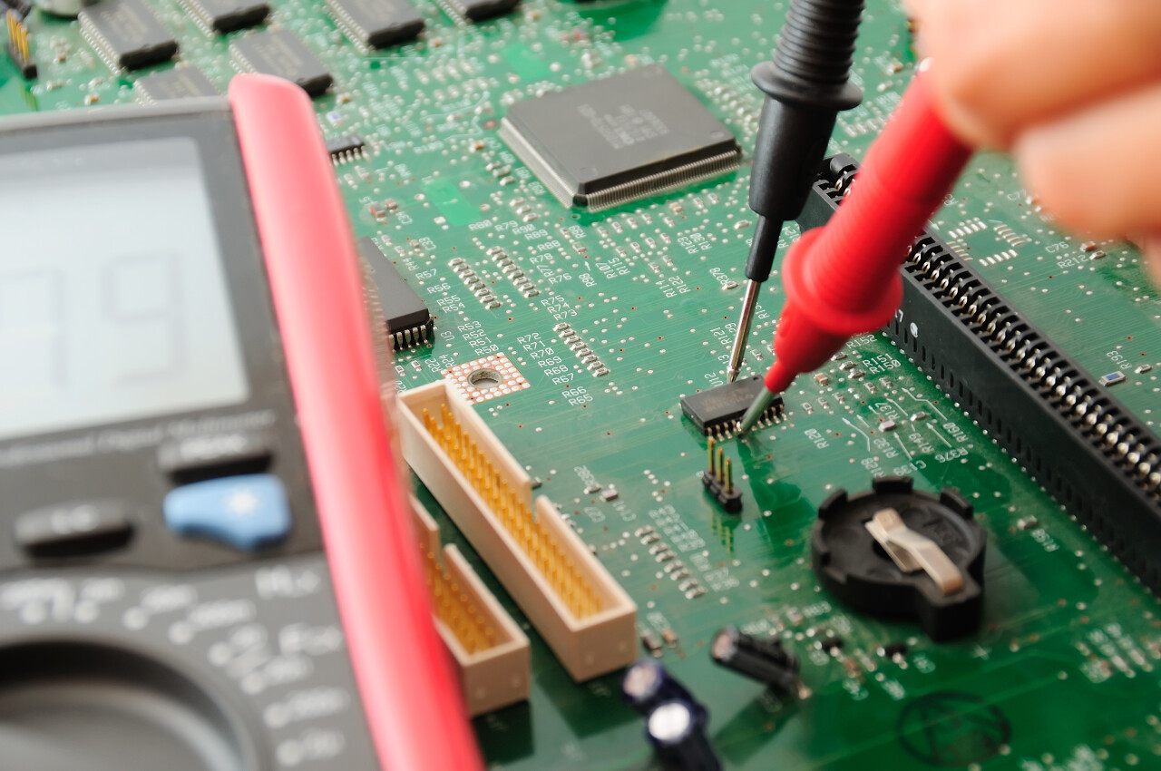 技术人员测试使用万用表的主板