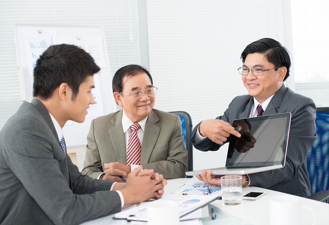 商务人士谈判讨论商议指着电脑交流成功人士商务沟通团队商务会议开会