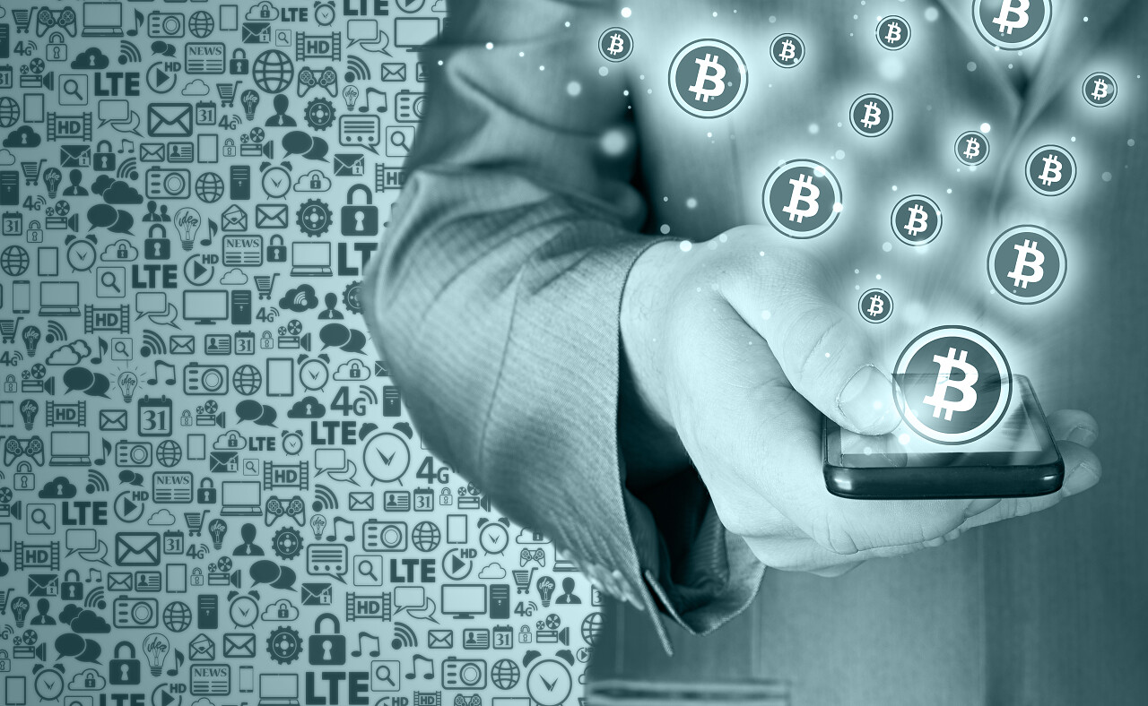 手用移动智能电话和比特币符号