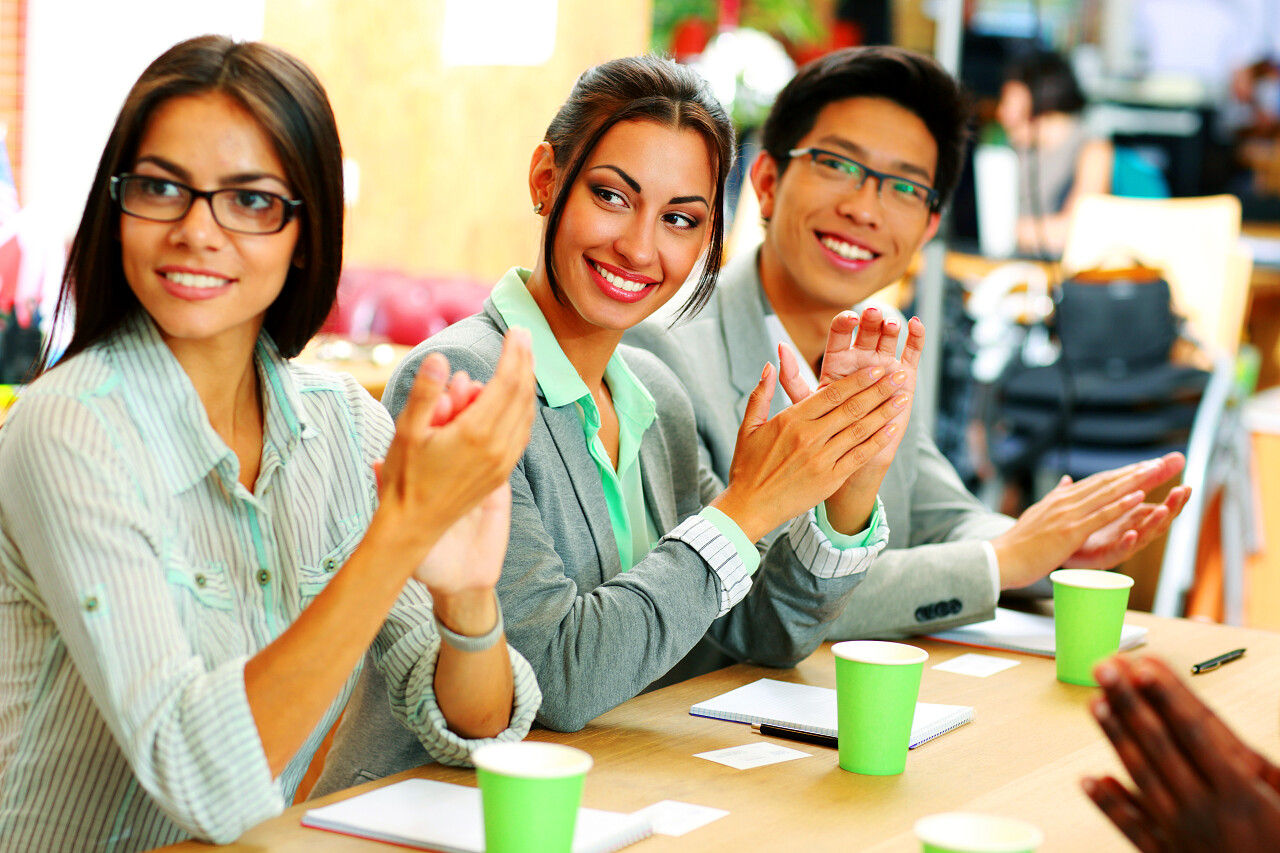 微笑的商界人士在会议上鼓掌成功