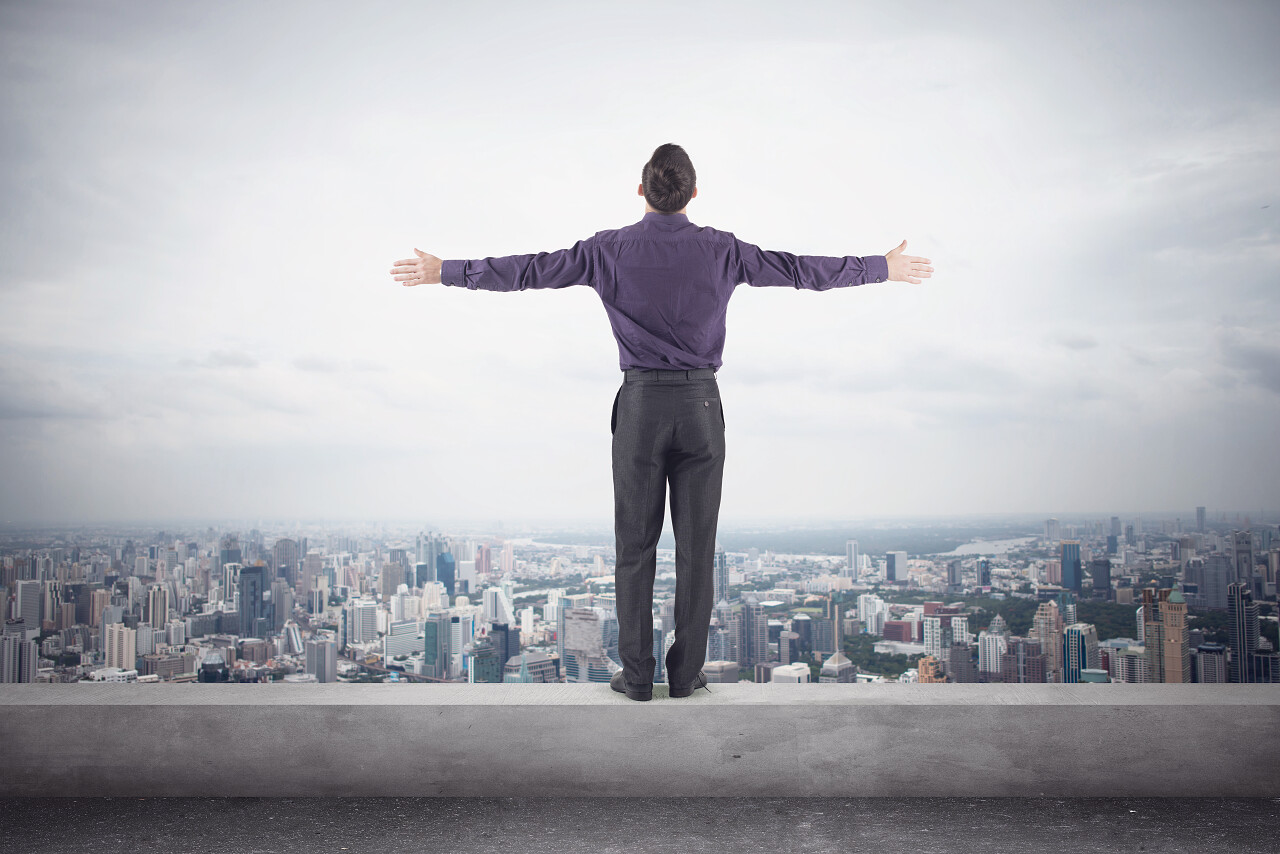 男人站在屋顶展开双臂