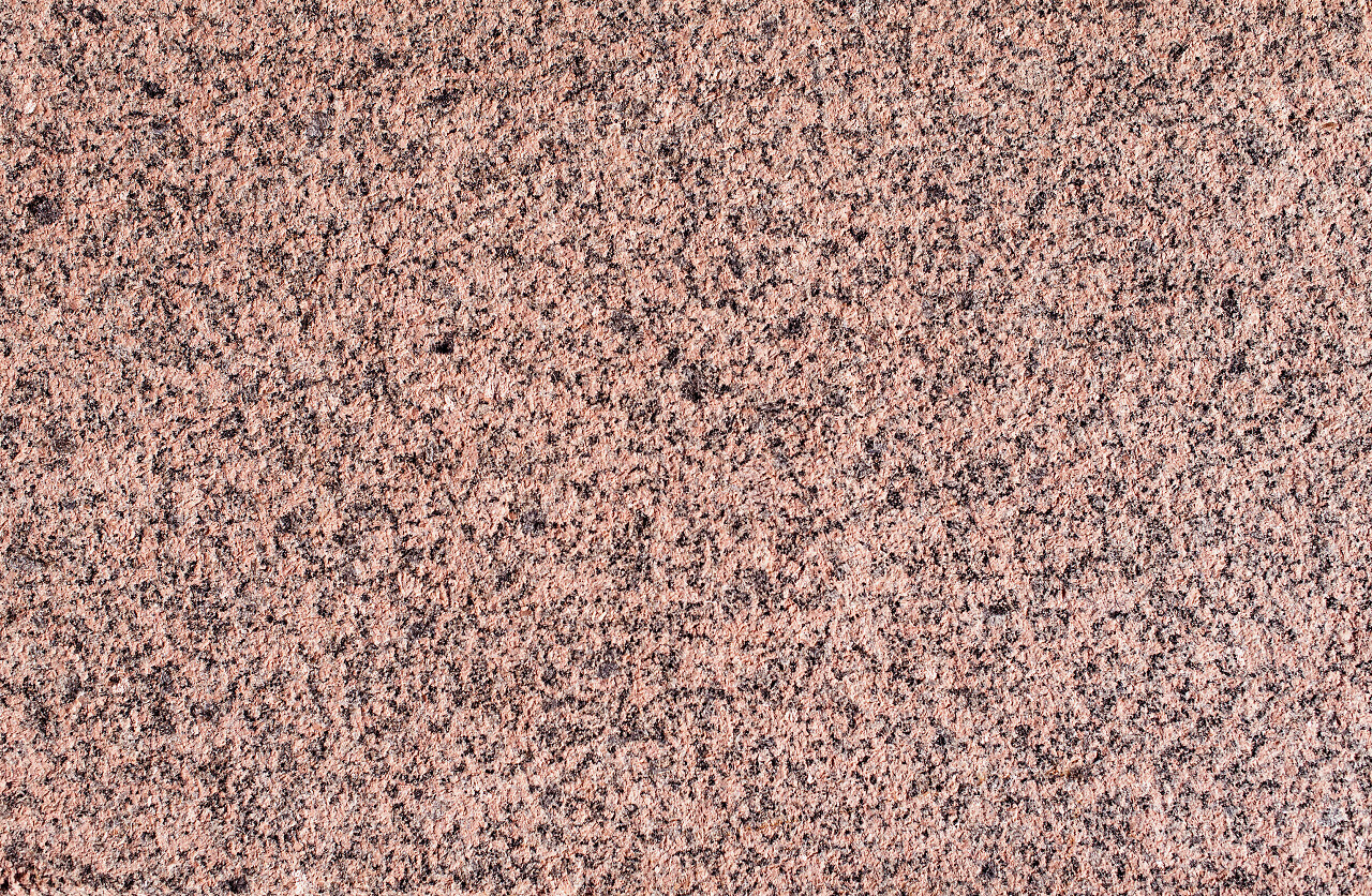 纹理的粉红色红色花岗岩背景图