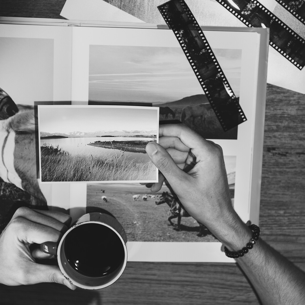 设影师在影集前拿着张照片