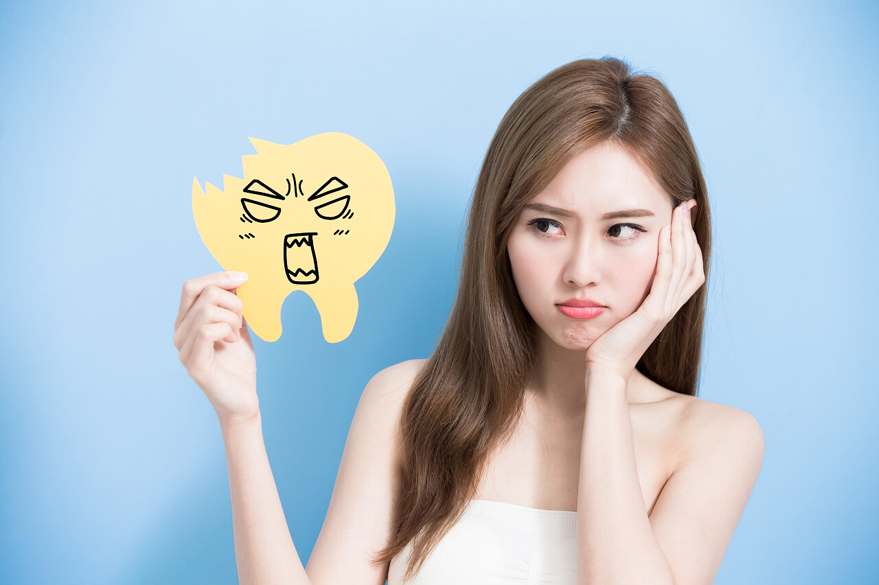 牙齿广告牌感到生气在蓝色背景上的女人