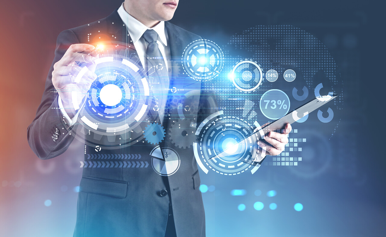 年轻商人手持一个发光的记号笔看着显示器