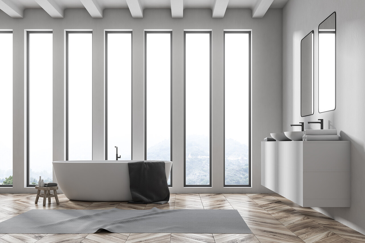 阁楼白色浴室角落里有一个木地板白色的浴缸小椅子双水槽