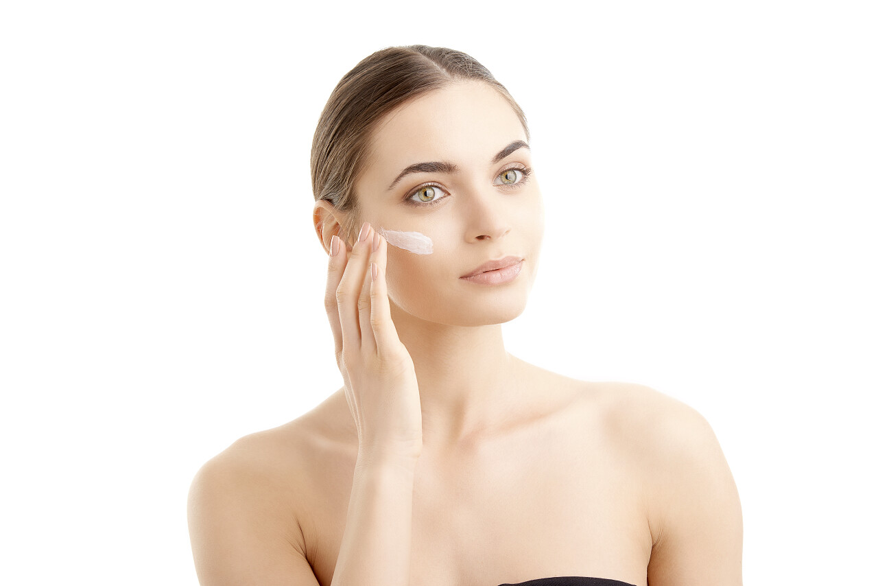 女人用润肤霜涂抹面部面部清洁脸部