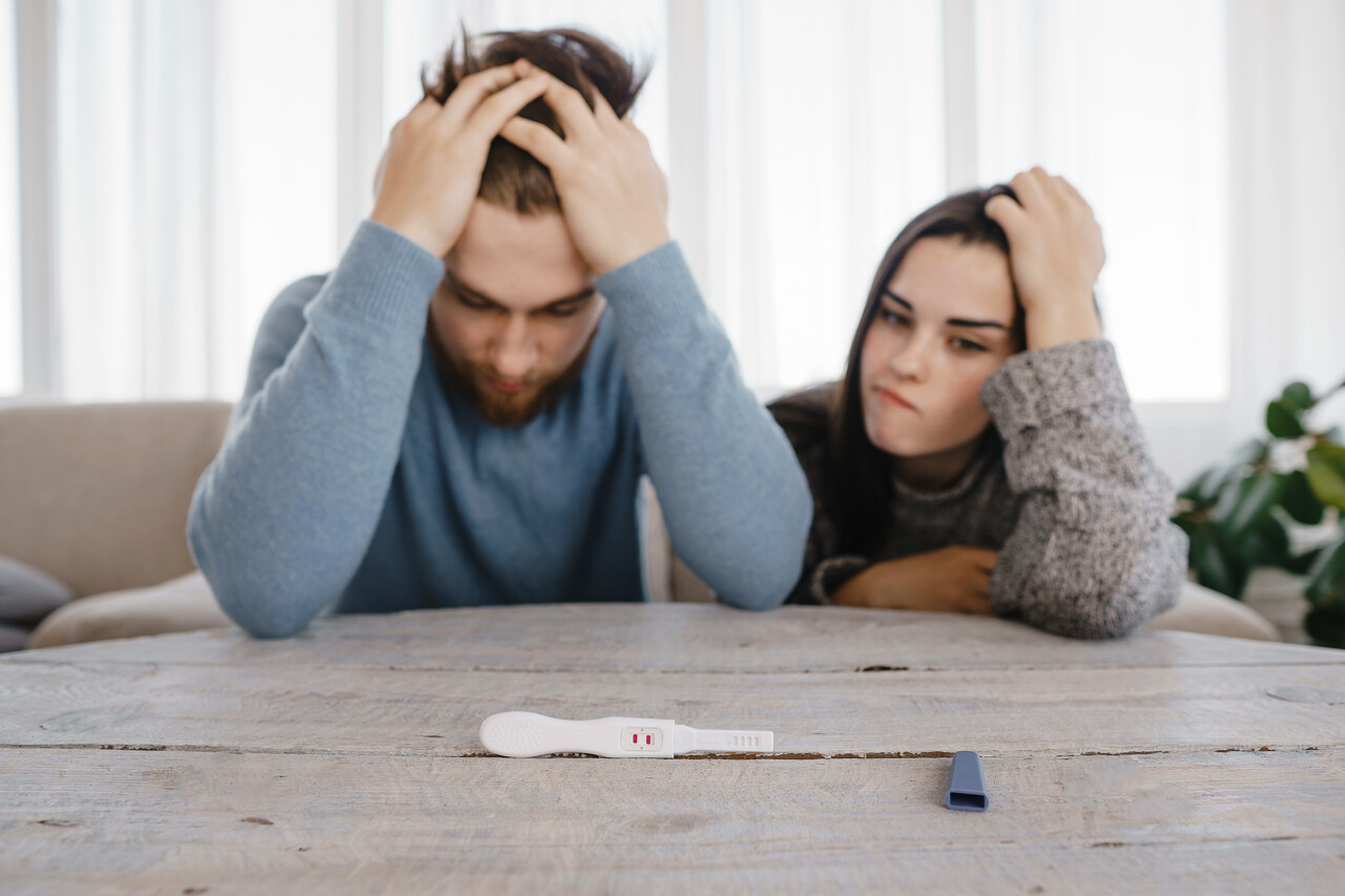 避孕失败安全的概念焦虑夫妇与阳性怀孕测试