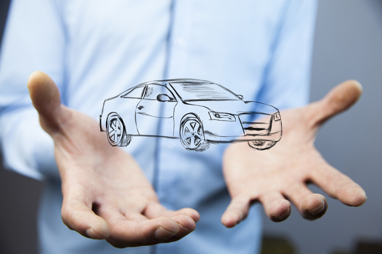 商人的手与汽车平面图标在灰色背景