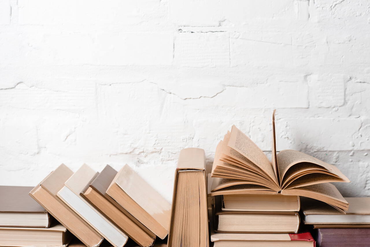 在白色砖墙附近有精装书读书分相会阅读世界读书日