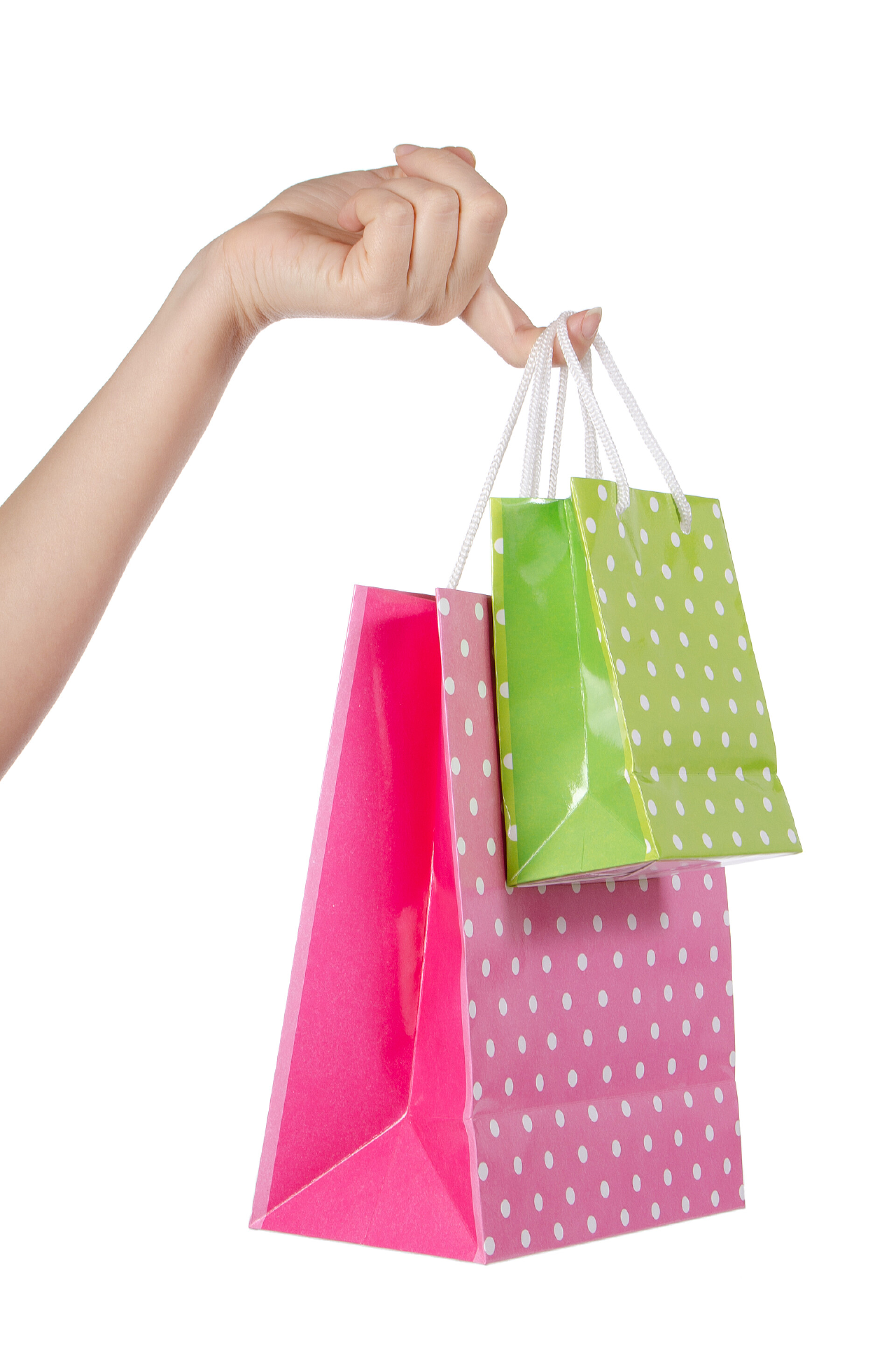 手指拎着购物袋在手上白色隔离明亮礼品袋