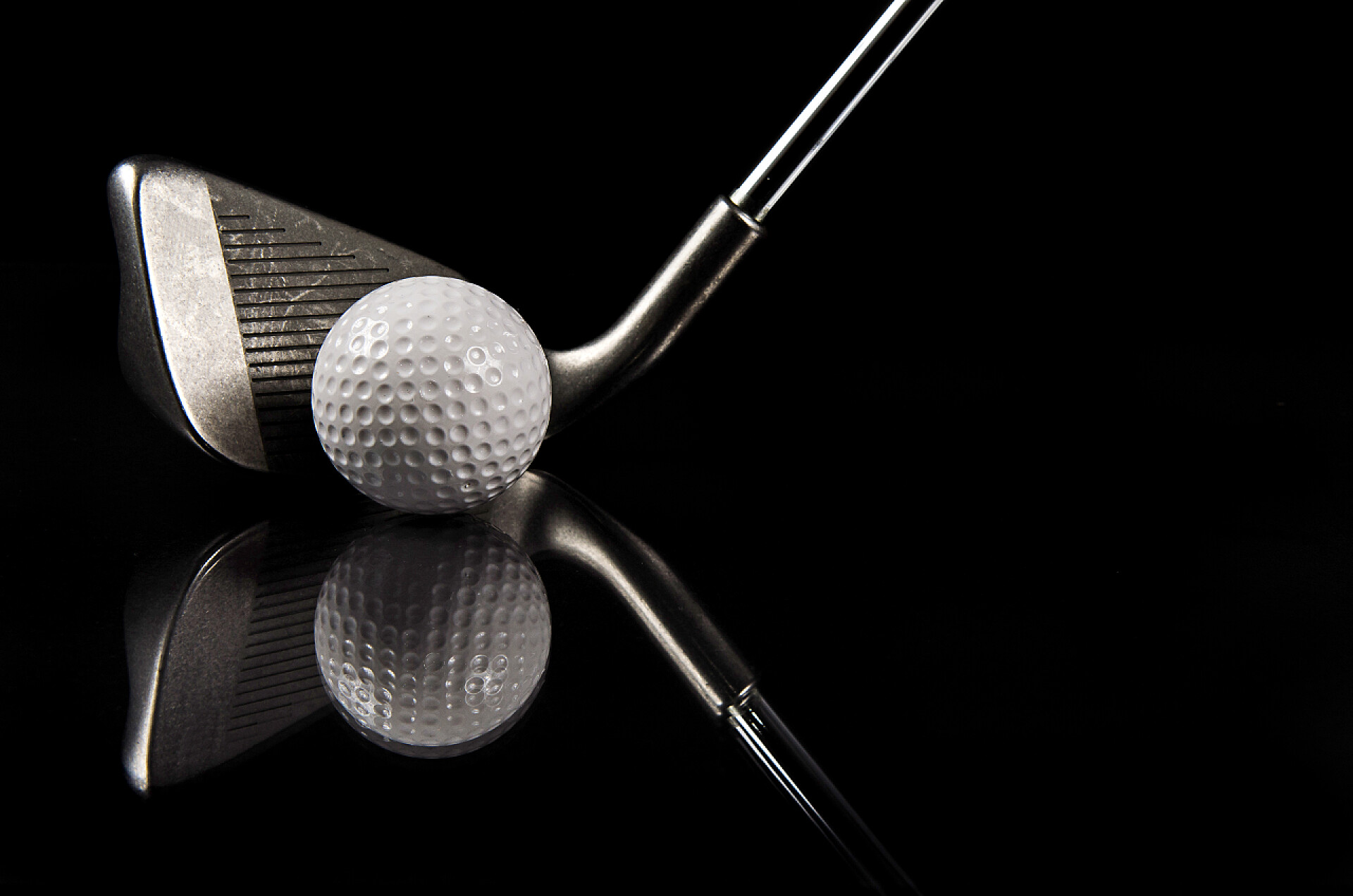 黑色背景上的高尔夫球和球杆高尔夫俱乐部