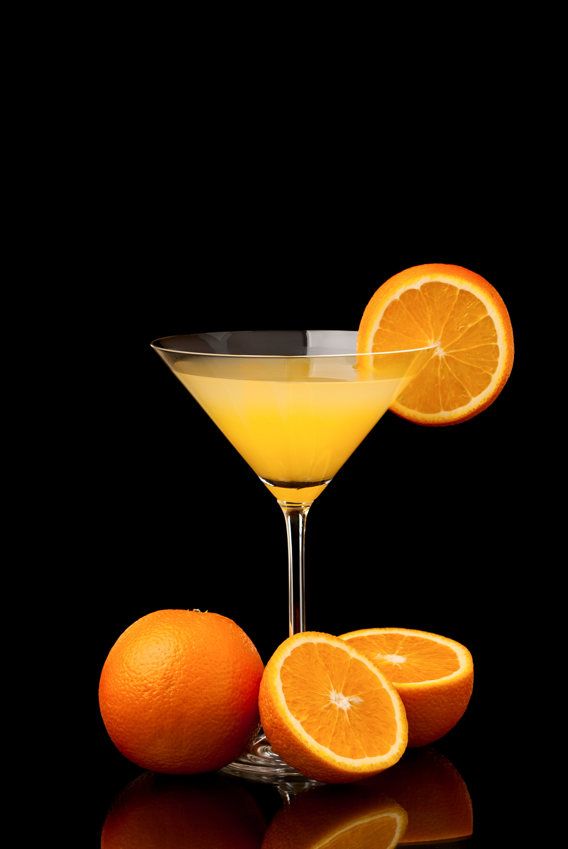 黑色背景上的橙汁橙子