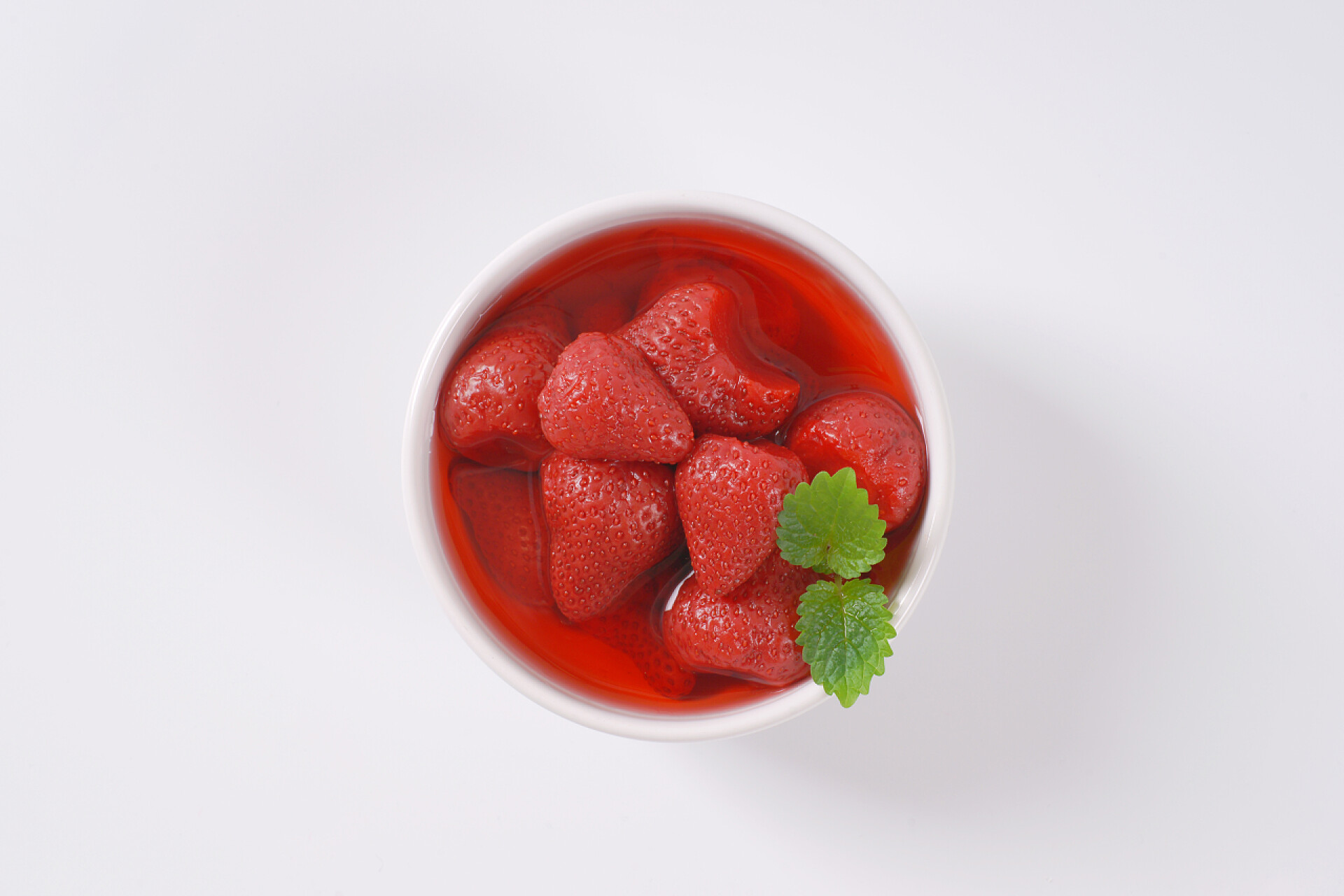 白色背景下放着草莓果盘碗里的草莓蜜饯