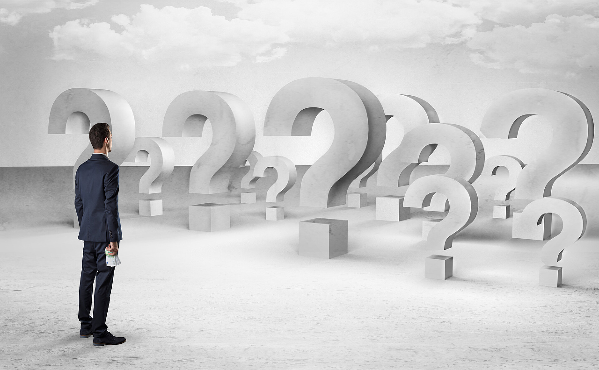 商务男士站在一堆问号前有很多问号标志和图标的人