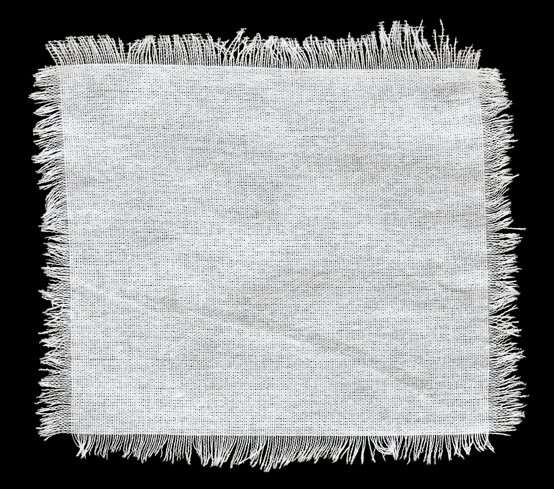 黑色背景中的一块亚麻布瓣麻布背景，一块天然的材料，可以用作背景与文本的空间.