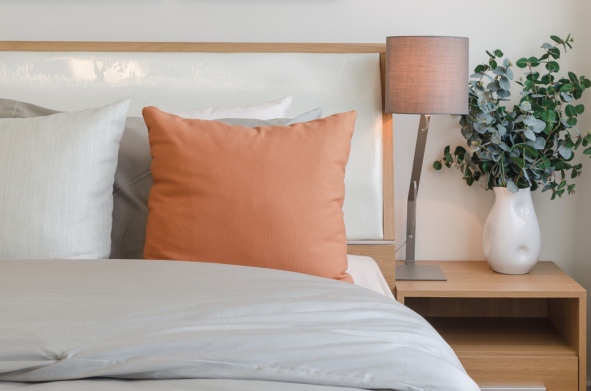 卧室床上的橘黄色枕头橘黄色枕头上白色的床在卧室里 