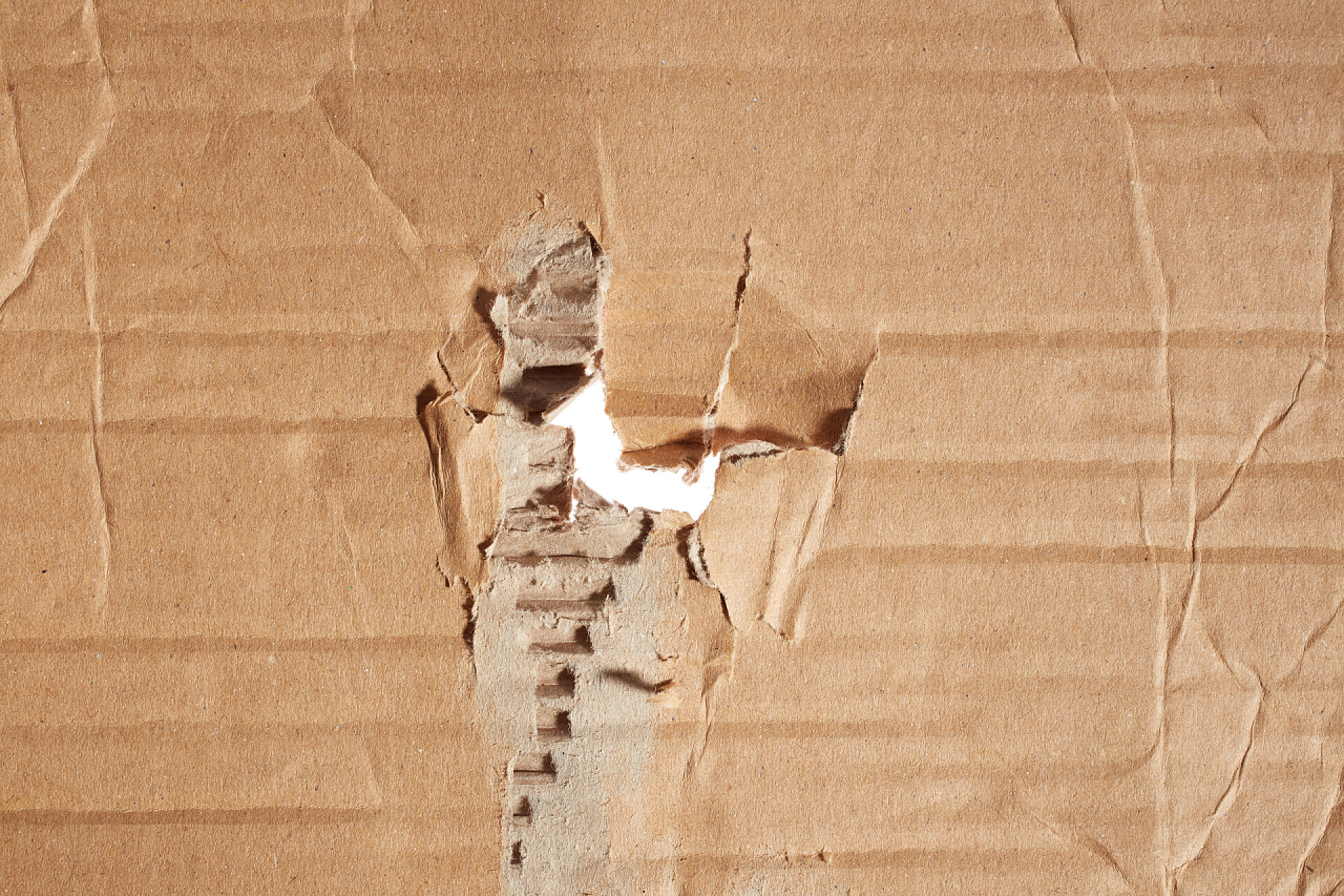 破损的纸箱在纸板的背景孔