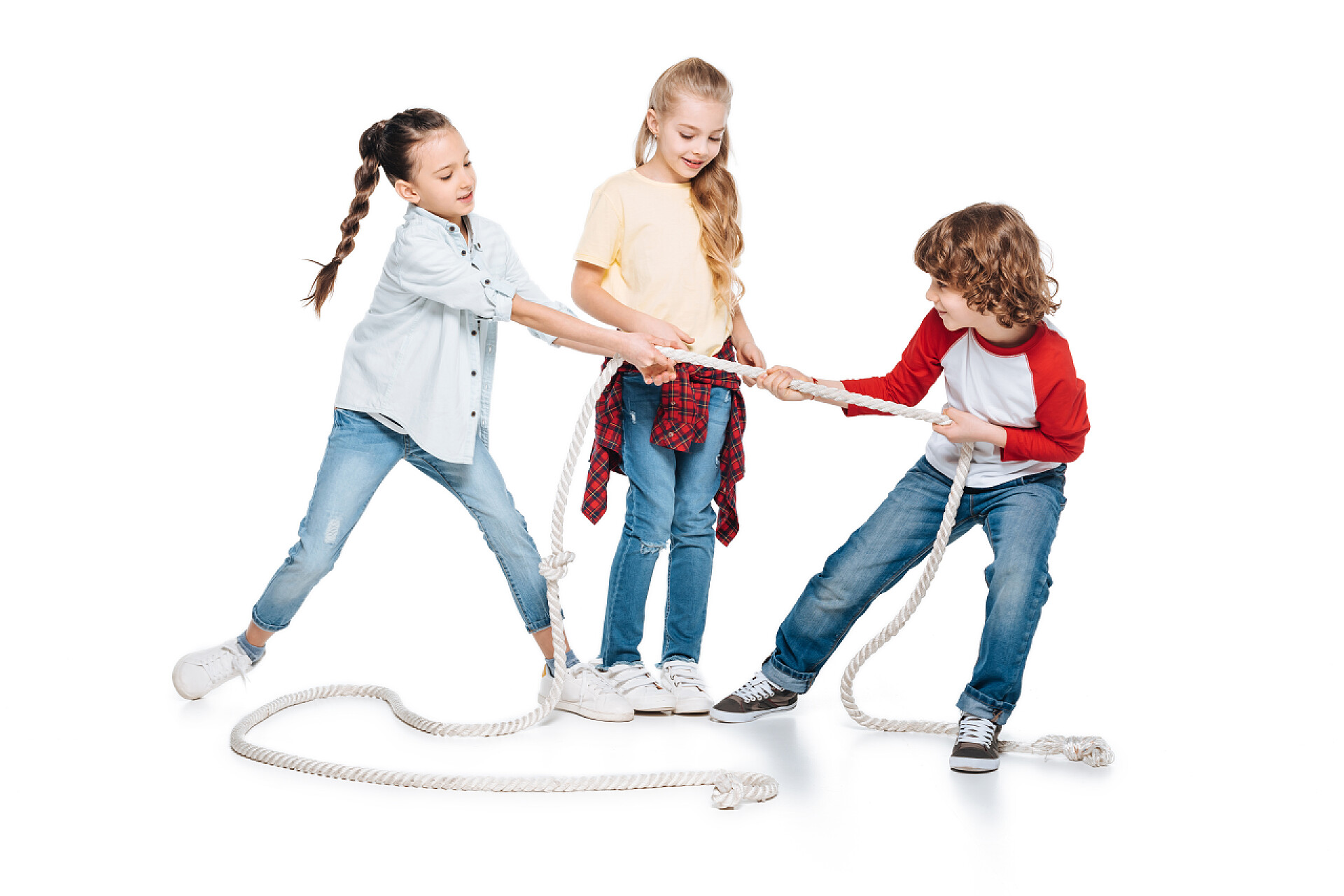 白色背景上玩拔河的三个孩子孩子们玩拔河