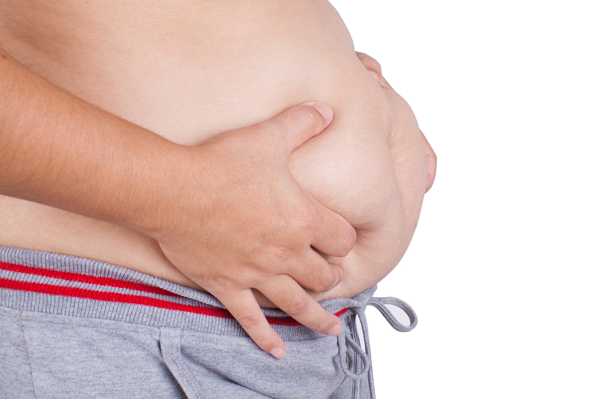 抚摸肚子上的肥肉的手特写镜头白色背景上的胖女人腹部表面