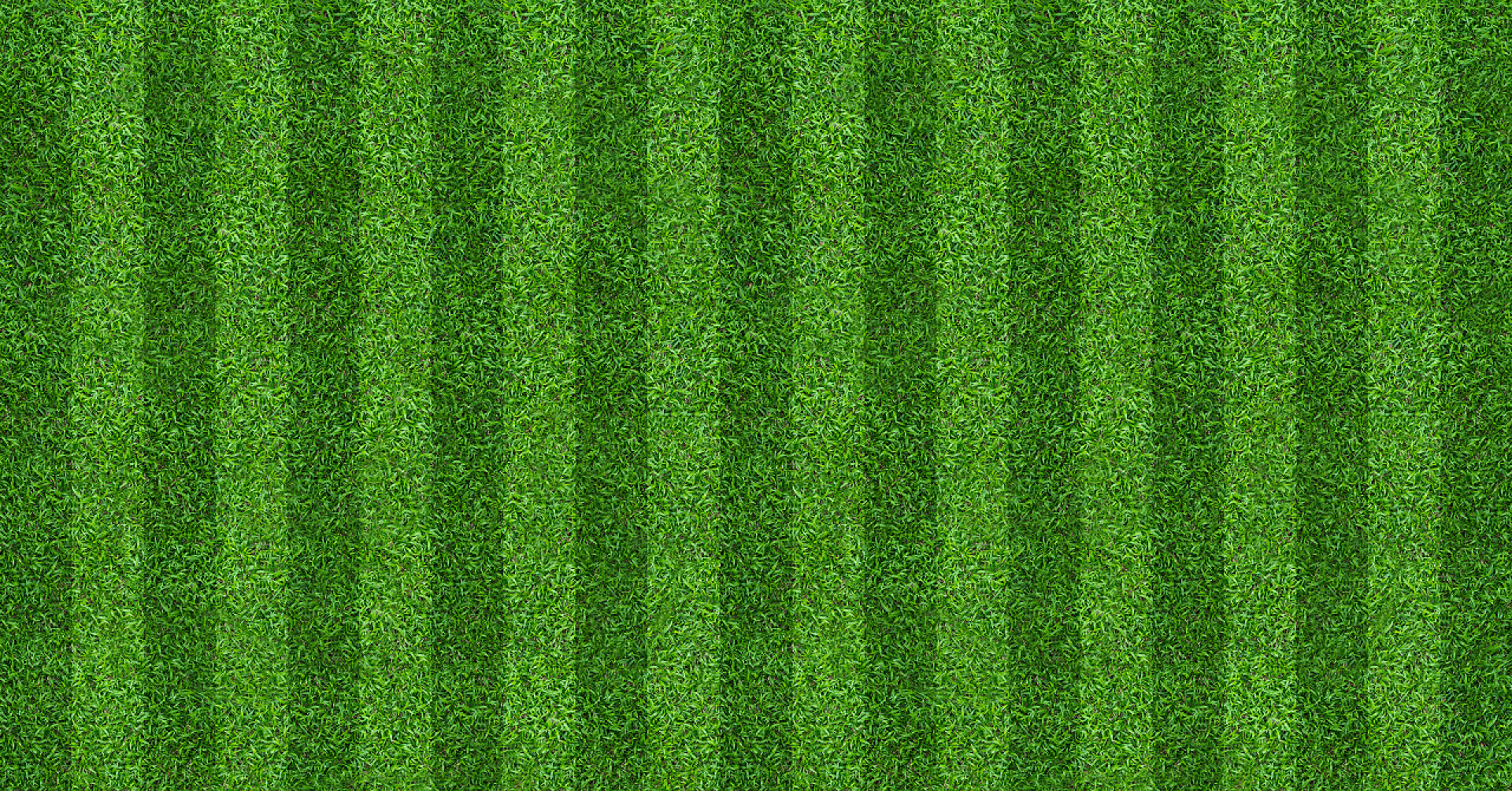 运动足球场的草坪足球和足球运动的绿草场背景。绿色草坪图案和纹理背景。特写镜头.