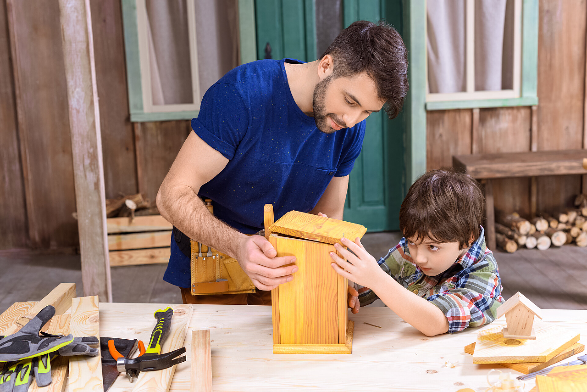 父亲带孩子制作鸟笼Father and son making birdhouse 