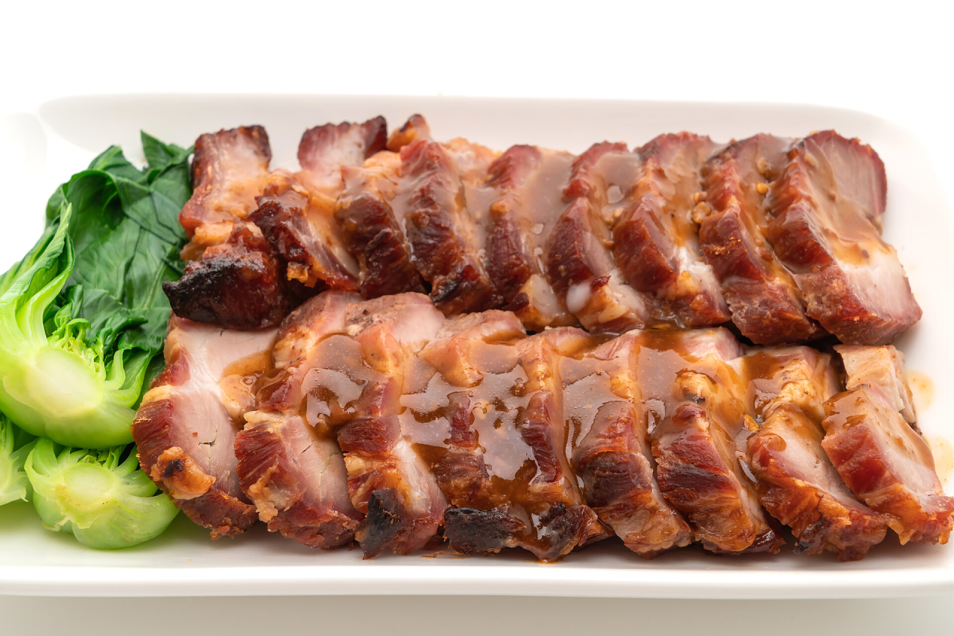 白色背景上一盘红烧猪肉烤烤肉红猪肉与酱汁查出在白色背景