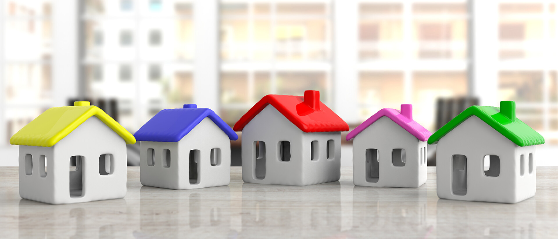 办公桌上的房子模型办公桌上的房子模型, 模糊的商业背景, 五颜六色的屋顶, 横幅。3d 插图