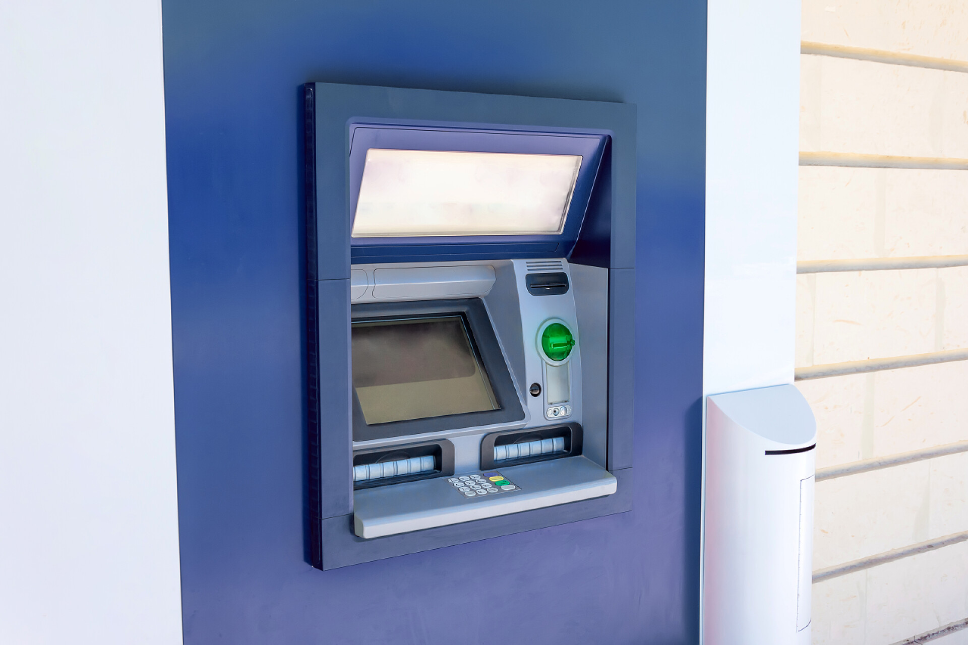 壁挂式提款机Atm提款机在城市街道一栋建筑的墙上，操作和功能，附近没有人.