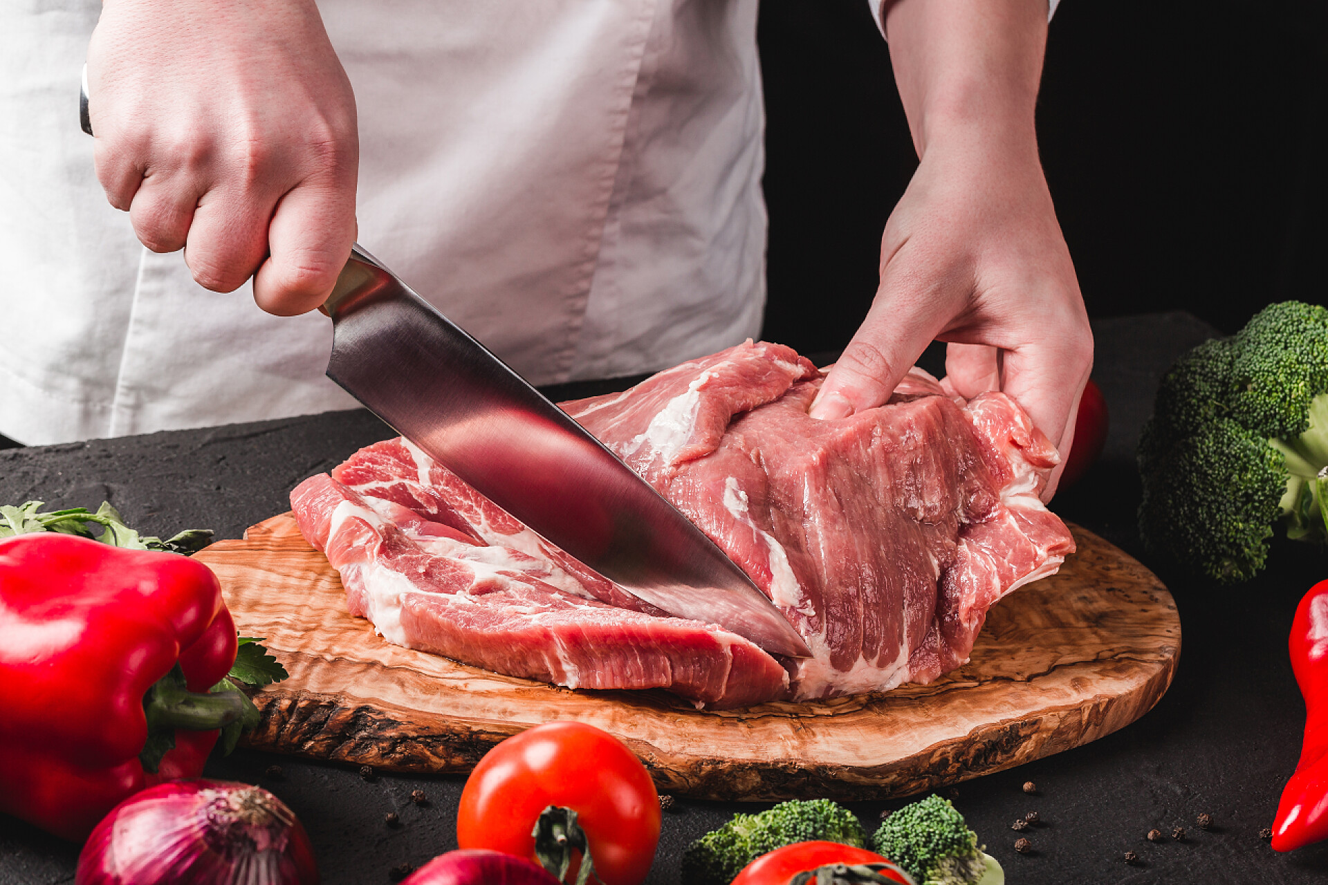 厨师用刀在切猪肉厨师屠夫切割猪肉用刀在厨房，烹饪fo