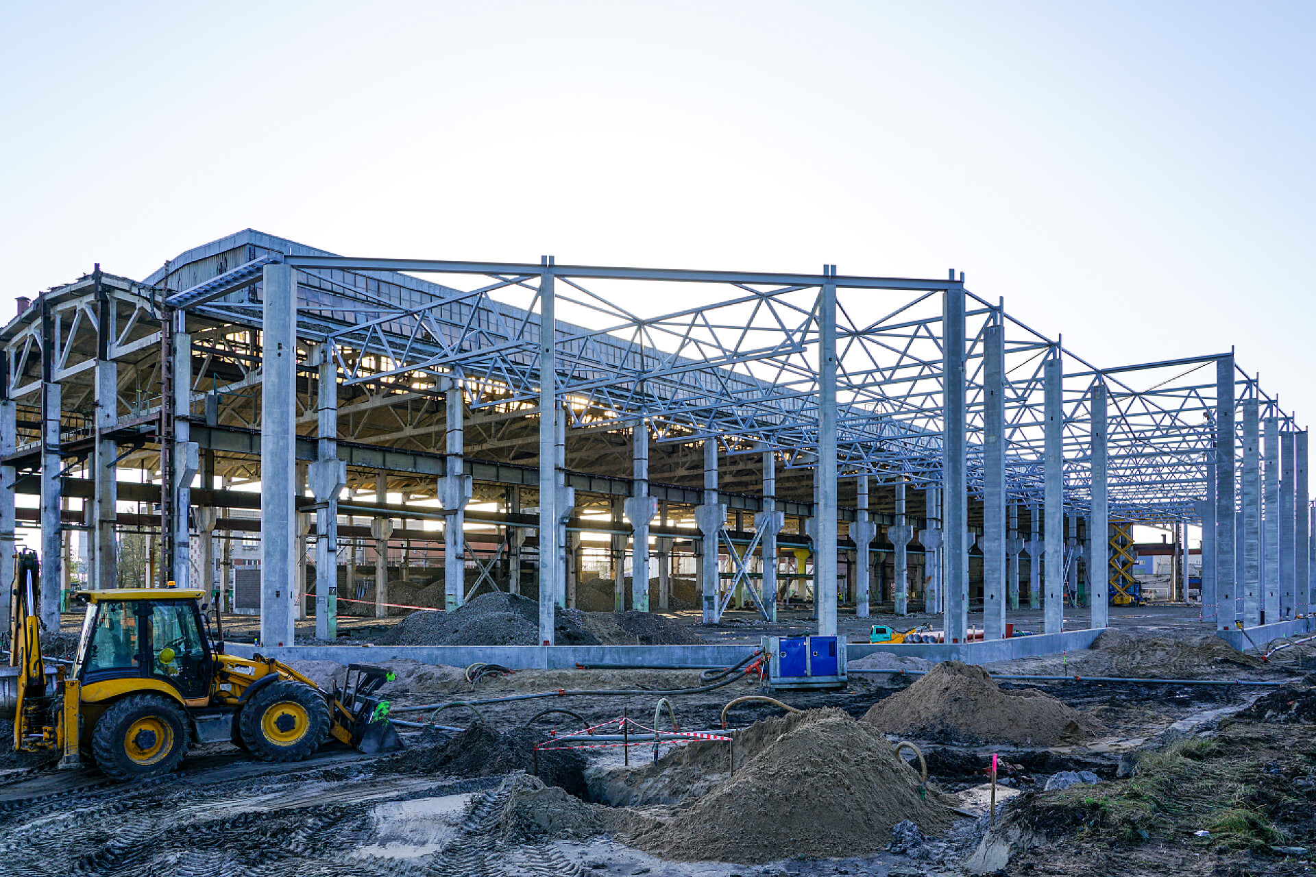 蓝天白云下一个正在施工的工地钢结构特写建造现代化工厂的主体，组装金属桁架