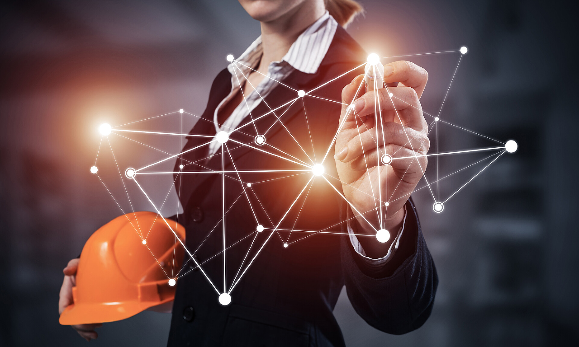 手拿安全帽的工程师女商人指向抽象的网络结构.身穿西装、头戴安全帽的女工程师。工程和项目管理。全球云技术和互联网通信