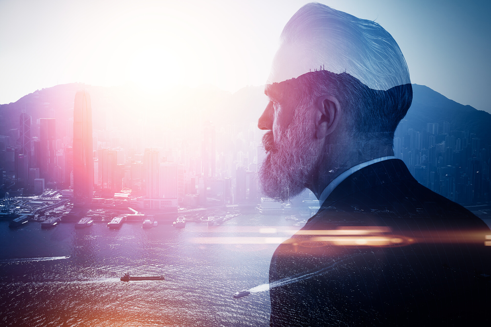 商务西装男面对高楼大厦现代化城市双重曝光