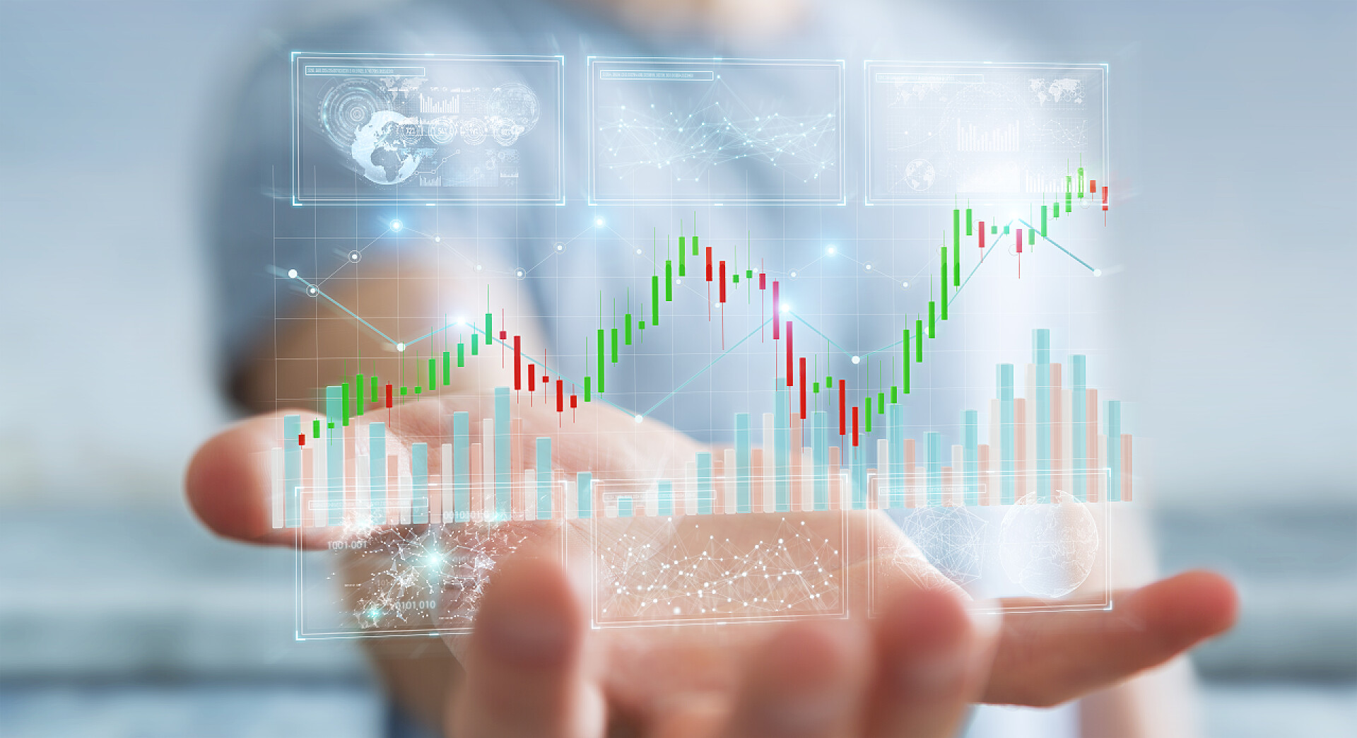 模糊背景下的商务人士手捧金融股票交易数据和图表