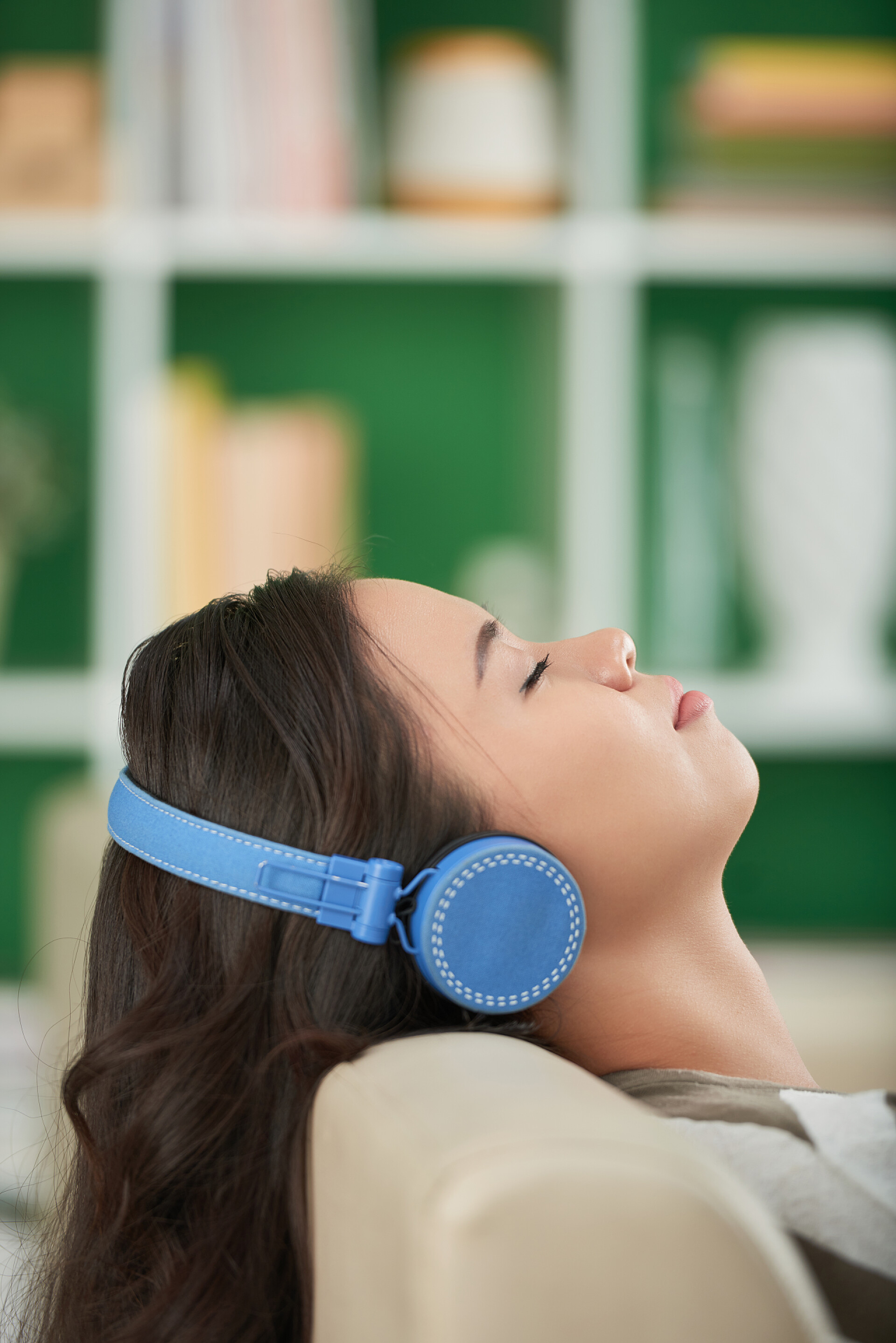 戴耳机的年轻女子在沙发上放松