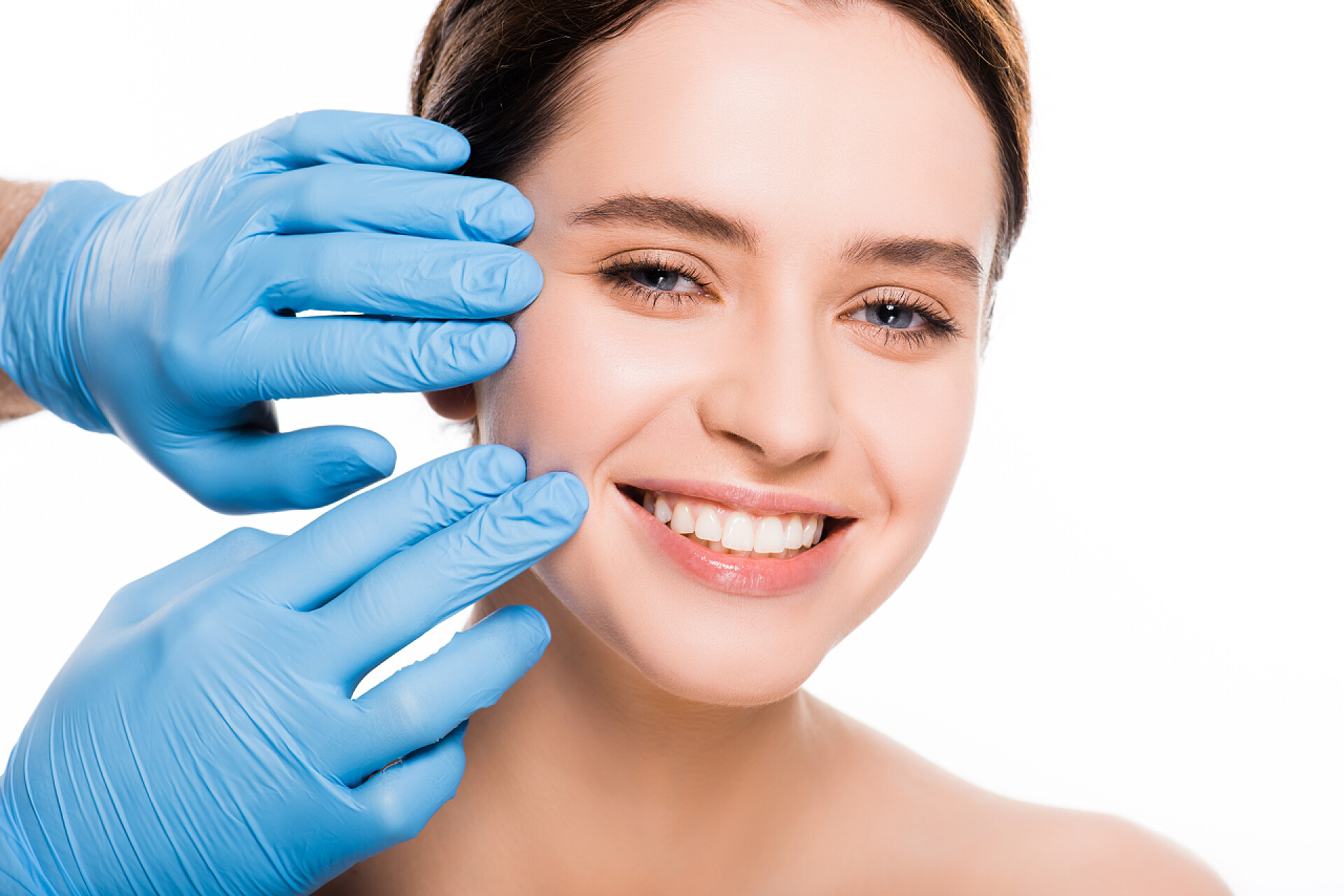 美容白色背景上整形外科医生触摸女孩的脸