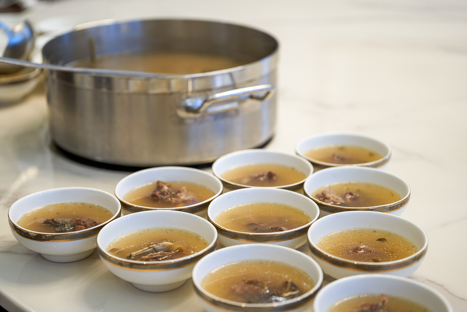 食物宾馆的服务员会把罐装鱼汤和广东菜汤分舀到碗里