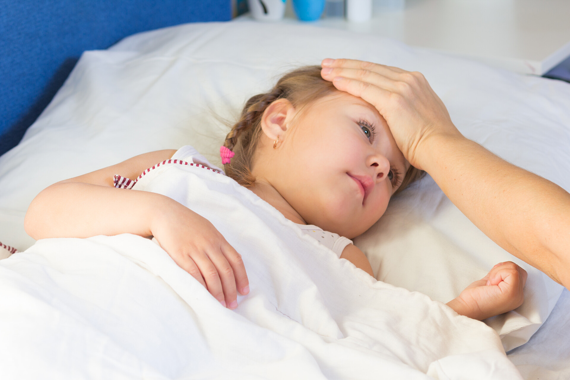 女人用手扶着孩子的额头感觉体温发烧生病