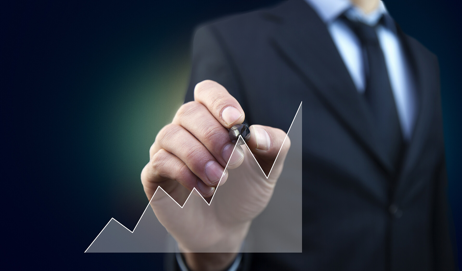 一个年轻的商人用笔绘制折线图商人商业商务