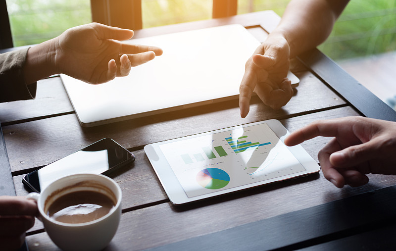 近距离的业务小组会议在平板设备上显示分析图